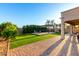 Expansive backyard featuring artificial turf, a charming pergola with seating, and mature landscaping for privacy at 19137 W Pasadena Ave, Litchfield Park, AZ 85340