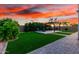 Beautiful backyard with a manicured lawn, stone pathway, and a pergola-covered seating area, perfect for outdoor relaxation at 19137 W Pasadena Ave, Litchfield Park, AZ 85340