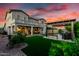 Expansive backyard with lush green lawn, a pergola covered outdoor seating area, and landscaped garden beds at 19137 W Pasadena Ave, Litchfield Park, AZ 85340