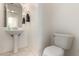 Clean, minimalist half bath featuring a pedestal sink and white fixtures at 19137 W Pasadena Ave, Litchfield Park, AZ 85340