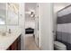 Bathroom with vanity and a view into a bedroom at 19137 W Pasadena Ave, Litchfield Park, AZ 85340