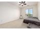 Bedroom with ceiling fan, large window and plush carpeting at 19137 W Pasadena Ave, Litchfield Park, AZ 85340