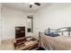 Bedroom with ceiling fan, patterned rug and ensuite bathroom at 19137 W Pasadena Ave, Litchfield Park, AZ 85340