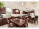 Bright dining room next to the kitchen with vaulted ceilings at 19137 W Pasadena Ave, Litchfield Park, AZ 85340