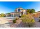 Inviting home exterior showcasing lush landscaping and a circular driveway at 19137 W Pasadena Ave, Litchfield Park, AZ 85340