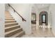 Inviting hallway featuring tiled floors, stairs, and archways leading to other rooms at 19137 W Pasadena Ave, Litchfield Park, AZ 85340