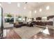 Bright living room with vaulted ceilings, oversized windows, and stylish furniture at 19137 W Pasadena Ave, Litchfield Park, AZ 85340