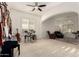 Bright living room highlighting a ceiling fan, neutral carpet and an adjoining lounge area at 19137 W Pasadena Ave, Litchfield Park, AZ 85340