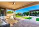 Inviting covered patio with comfortable seating and a well-manicured lawn, perfect for outdoor relaxation and entertainment at 19137 W Pasadena Ave, Litchfield Park, AZ 85340