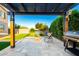 Backyard pergola featuring seating and a grill, framed by lush landscaping for outdoor enjoyment and relaxation at 19137 W Pasadena Ave, Litchfield Park, AZ 85340