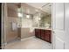 Modern bathroom featuring a glass-enclosed shower and double sink vanity with warm wood cabinetry at 19675 E Oriole Way, Queen Creek, AZ 85142