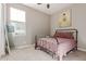 Charming bedroom with an iron bed frame, soft pink bedding, and a bright window at 19675 E Oriole Way, Queen Creek, AZ 85142