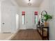 Bright and inviting home entry with decorative tile flooring, a hall table, and a stylish mirror at 19675 E Oriole Way, Queen Creek, AZ 85142