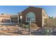 Close-up of a home's front exterior with rock landscaping and desert plants at 19675 E Oriole Way, Queen Creek, AZ 85142