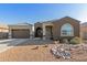 Single-story home with a three-car garage, desert landscaping, and a charming front porch at 19675 E Oriole Way, Queen Creek, AZ 85142