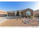 Single-story home with a three-car garage, desert landscaping, and a charming front porch at 19675 E Oriole Way, Queen Creek, AZ 85142