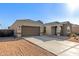 Inviting single-story home featuring a two-car garage and desert landscaping under a clear blue sky at 19675 E Oriole Way, Queen Creek, AZ 85142