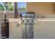 A stainless steel BBQ grill with a Turbo logo is installed on the outdoor kitchen's countertop at 19675 E Oriole Way, Queen Creek, AZ 85142