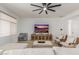 Bright living room featuring modern furniture, a flat screen television, and neutral decor at 19675 E Oriole Way, Queen Creek, AZ 85142