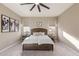 Inviting main bedroom with a rustic wood headboard, plush carpet, and soft neutral tones at 19675 E Oriole Way, Queen Creek, AZ 85142