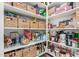 Organized walk-in pantry with well-stocked shelves of food items and woven baskets at 19675 E Oriole Way, Queen Creek, AZ 85142