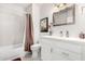 Bright bathroom with shower-tub combo, updated vanity and mirror, and decorative accents at 19777 N 76Th St # 1219, Scottsdale, AZ 85255