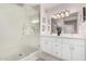 Modern bathroom featuring a glass shower, double vanity with white cabinets, and bright lighting at 19777 N 76Th St # 1219, Scottsdale, AZ 85255