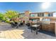 Beautiful outdoor kitchen featuring stainless steel grills, a dining area, and a cozy fireplace at 19777 N 76Th St # 1219, Scottsdale, AZ 85255