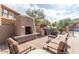 Relaxing outdoor kitchen with built-in grill, adobe fireplace, and cozy seating, perfect for entertaining guests at 19777 N 76Th St # 1219, Scottsdale, AZ 85255