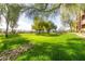 Lush green park features mature trees and a rock-lined stream, creating a peaceful outdoor setting at 19777 N 76Th St # 1219, Scottsdale, AZ 85255