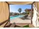 Relaxing poolside view from a shaded cabana, showcasing the community pool and lounge area at 19777 N 76Th St # 1219, Scottsdale, AZ 85255