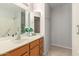 Bathroom features a vanity with modern sink and generous cabinet space and large mirror at 19820 N 13Th Ave # 169, Phoenix, AZ 85027