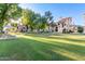 Exterior view of the residential community with a lush green common area at 19820 N 13Th Ave # 169, Phoenix, AZ 85027