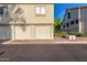 View of condo garages and a lush common area at 19820 N 13Th Ave # 169, Phoenix, AZ 85027