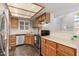 A bright kitchen features wood cabinets, a stainless steel dishwasher, and tile floors at 19820 N 13Th Ave # 169, Phoenix, AZ 85027