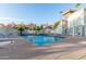 Community swimming pool surrounded by lounge chairs and lush landscaping at 19820 N 13Th Ave # 169, Phoenix, AZ 85027