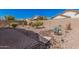 The landscaped backyard features a dry riverbed and desert vegetation, creating a serene outdoor space at 208 W Lantern Way, San Tan Valley, AZ 85143