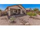 Charming backyard view with covered patio, desert plants, and rock landscaping at 208 W Lantern Way, San Tan Valley, AZ 85143