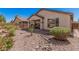 Landscaped backyard with a covered patio and rock features, perfect for outdoor entertaining at 208 W Lantern Way, San Tan Valley, AZ 85143