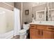 Bathroom with a shower-tub combo, a toilet and a wooden vanity with a sink and mirror at 208 W Lantern Way, San Tan Valley, AZ 85143