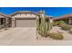 Charming home featuring a desert landscape, a two-car garage, and an inviting entrance at 208 W Lantern Way, San Tan Valley, AZ 85143