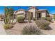 Beautiful home showcasing the desert landscape, a two-car garage, and an inviting entrance at 208 W Lantern Way, San Tan Valley, AZ 85143