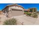 Picture of a garage with desert landscaping and a wide drive way at 208 W Lantern Way, San Tan Valley, AZ 85143