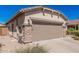 Picture of a garage with desert landscaping and a wide drive way at 208 W Lantern Way, San Tan Valley, AZ 85143