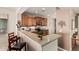 A well-lit kitchen with stainless steel appliances and wooden cabinets, with a breakfast bar at 208 W Lantern Way, San Tan Valley, AZ 85143