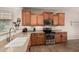 Well-lit kitchen with stainless steel appliances and wooden cabinets at 208 W Lantern Way, San Tan Valley, AZ 85143