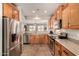 Bright eat-in kitchen featuring stainless steel appliances and a pass through to the dining area with natural light at 208 W Lantern Way, San Tan Valley, AZ 85143