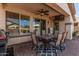 Cozy covered patio with a dining table, outdoor furniture, and a mounted TV at 208 W Lantern Way, San Tan Valley, AZ 85143