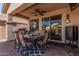 Outdoor patio with a dining table, grill, and a view of neighboring houses at 208 W Lantern Way, San Tan Valley, AZ 85143