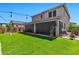 Spacious backyard featuring green lawn, string lights, and privacy screen at 20846 E Longwood Dr, Queen Creek, AZ 85142